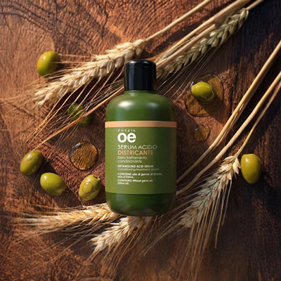 immagine del prodotto del serum acido  ambientato su sfondo marrone con grano e olive